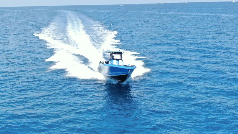 Slide: The Image of 2023 Statement 380 Open boat cruising on open blue ocean waters. - 25