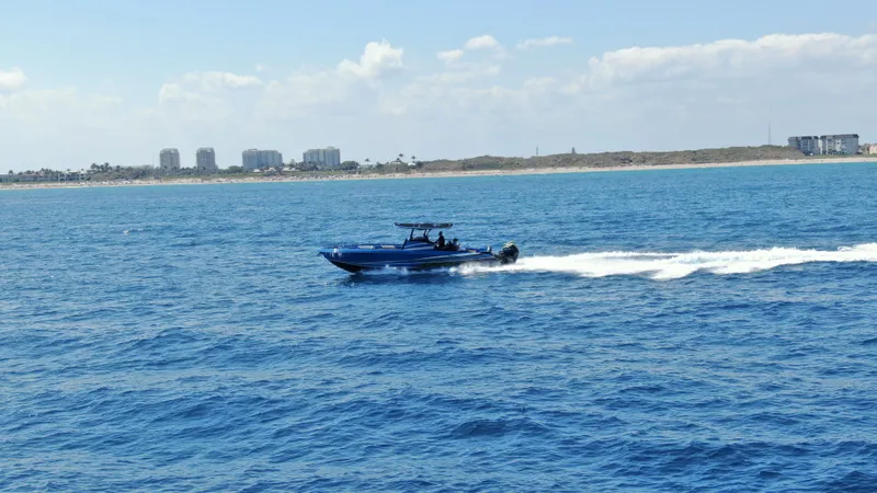 Slide: The Image of 2023 Statement 380 Open boat cruising on open blue ocean waters. - 27