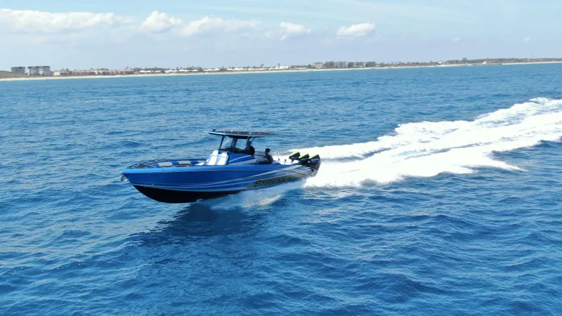 Slide: The Image of 2023 Statement 380 Open boat cruising on open blue ocean waters. - 28