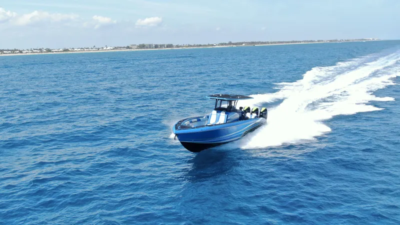 Slide: The Image of Triple Mercury Racing engines on 2023 Statement 380 Open boat, cruising on water. - 29