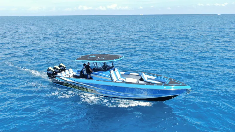 Slide: The Image of 2023 Statement 380 Open boat cruising on clear blue ocean waters. - 3