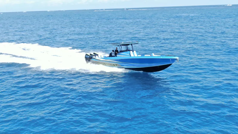 Slide: The Image of 2023 Statement 380 Open speedboat cruising on open blue ocean waters. - 4