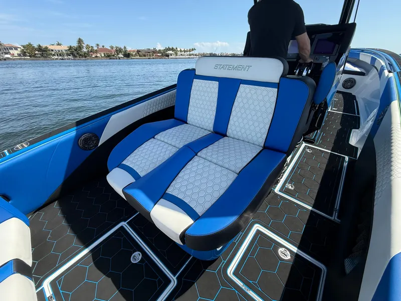 Slide: The Image of 2023 Statement 380 Open boat interior with blue and white seating, hexagonal floor pattern. - 44