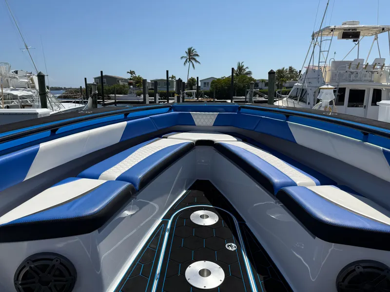 Slide: The Image of 2023 Statement 380 Open boat interior with blue and white seating, hexagonal flooring, and speakers. - 46