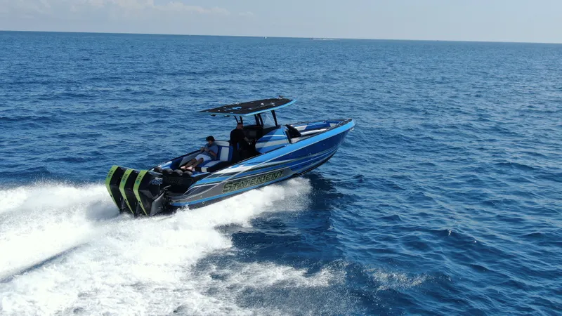 Slide: The Image of 2023 Statement 380 Open boat cruising on open sea, showcasing sleek design and powerful engines. - 7