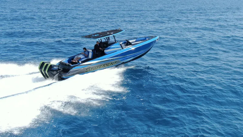 Slide: The Image of 2023 Statement 380 Open boat cruising on clear blue ocean waters. - 9