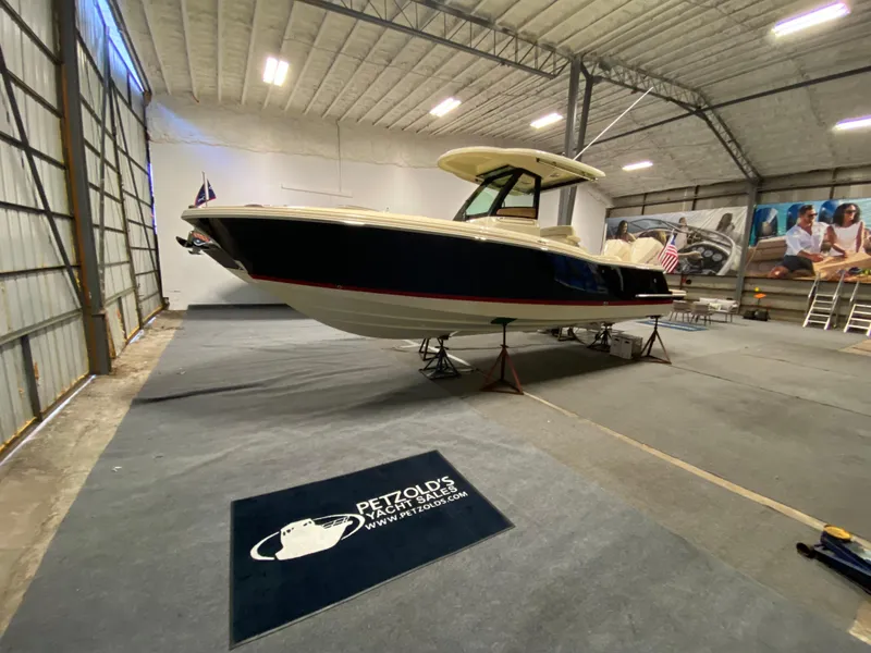 Slide: The Image of 2026 Chris-Craft Catalina 28 boat in a spacious indoor storage facility. - 2