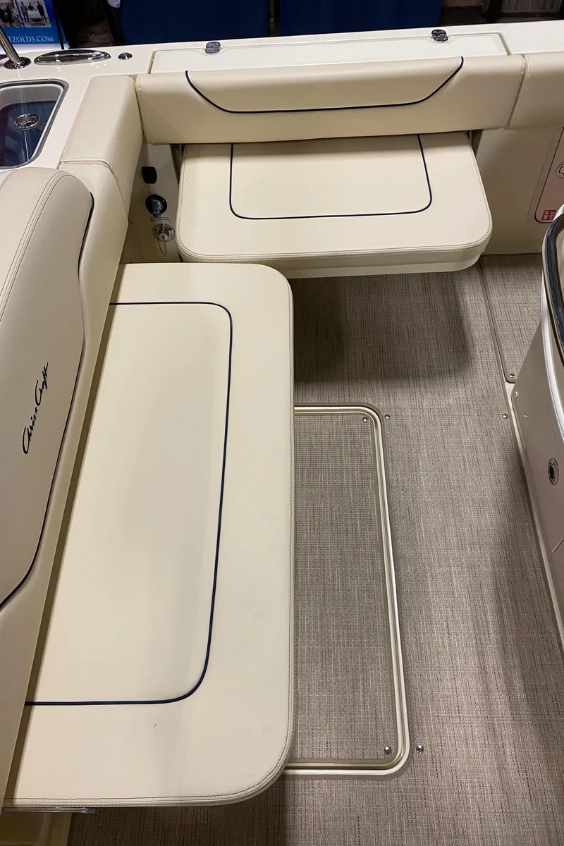 Slide: The Image of 2026 Chris-Craft Catalina 28 interior with beige seating and flooring. - 7