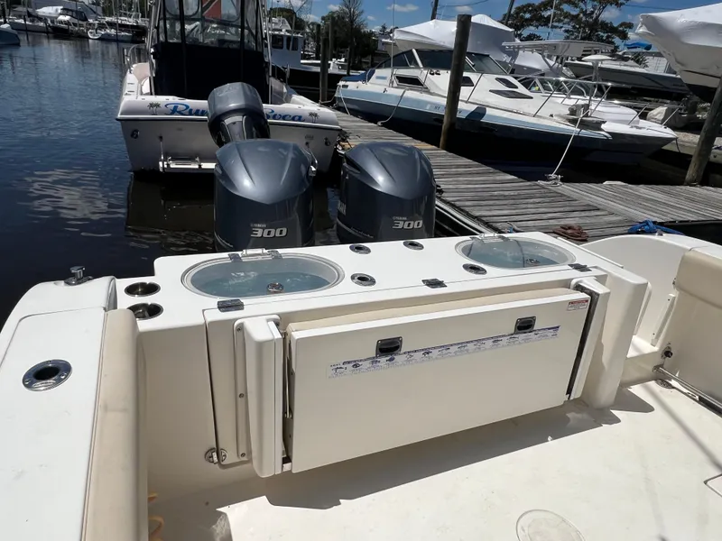 Slide: The Image of 2014 Cobia 296 Center Console boat with twin 300 engines docked at marina. - 20