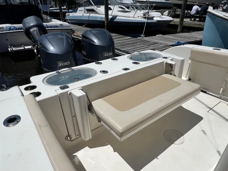 Slide: The Image of 2014 Cobia 296 Center Console boat with twin 300 engines and foldable seating. - 21