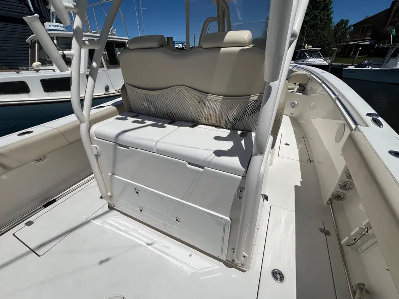 Slide: The Image of 2014 Cobia 296 Center Console boat interior with seating and storage. - 22