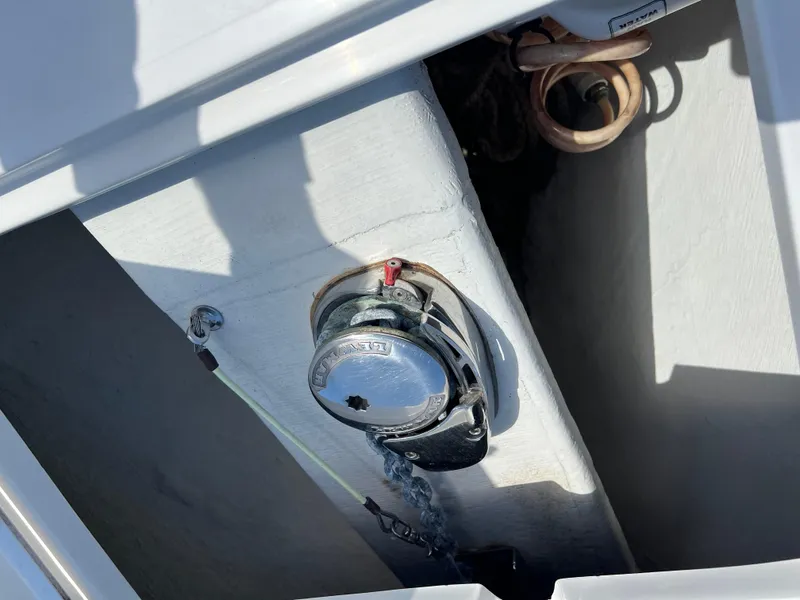 Slide: The Image of 2014 Cobia 296 Center Console boat anchor compartment with winch and chain. - 28