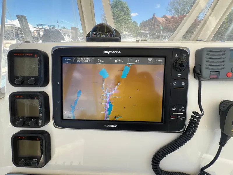 Slide: The Image of Cobia 296 Center Console 2014 dashboard with Raymarine navigation system and marine electronics. - 30