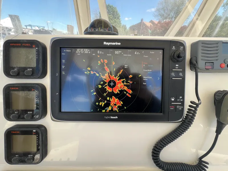 Slide: The Image of 2014 Cobia 296 Center Console dashboard with Raymarine navigation display and gauges. - 32