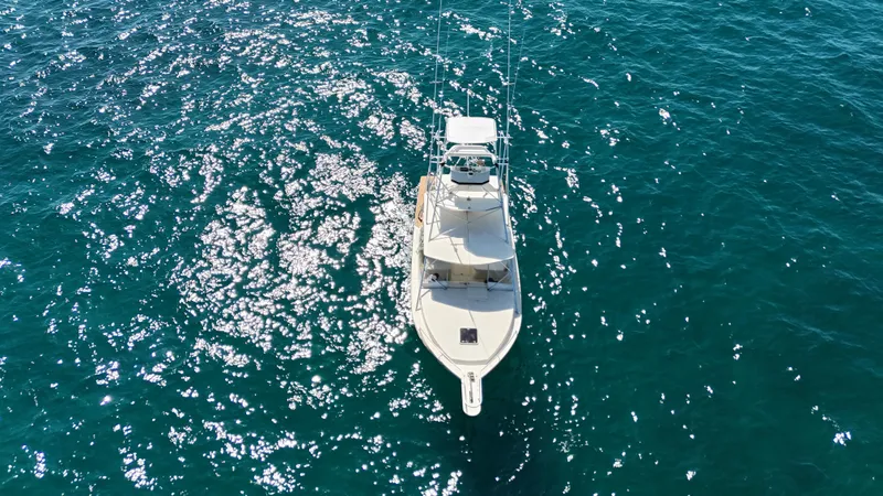 Slide: The Image of Aerial view of 1990 Gulf Stream Yachts 31 Tournament on sparkling blue water. - 10