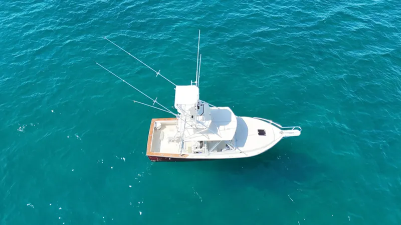 Slide: The Image of Aerial view of 1990 Gulf Stream Yachts 31 Tournament on blue ocean water. - 11