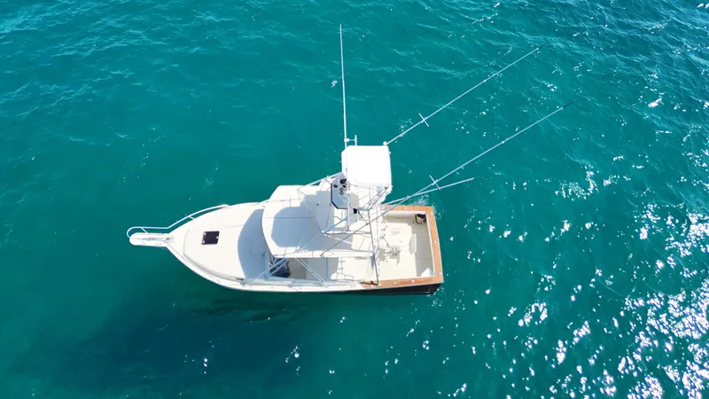 Slide: The Image of Aerial view of 1990 Gulf Stream Yachts 31 Tournament on clear blue water. - 13