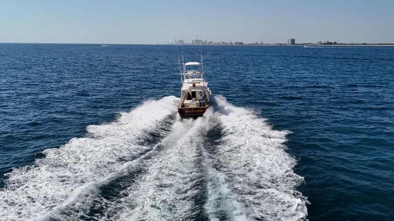 Slide: The Image of Gulf Stream Yachts 31 Tournament 1990 cruising on open sea, leaving a wake behind. - 15