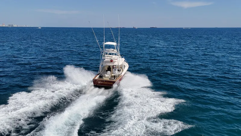 Slide: The Image of 1990 Gulf Stream Yachts 31 Tournament cruising on open sea, leaving a wake behind. - 17