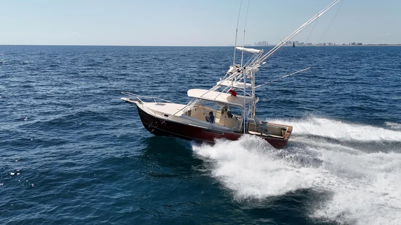 Slide: The Image of 1990 Gulf Stream Yachts 31 Tournament cruising on open ocean waters. - 19