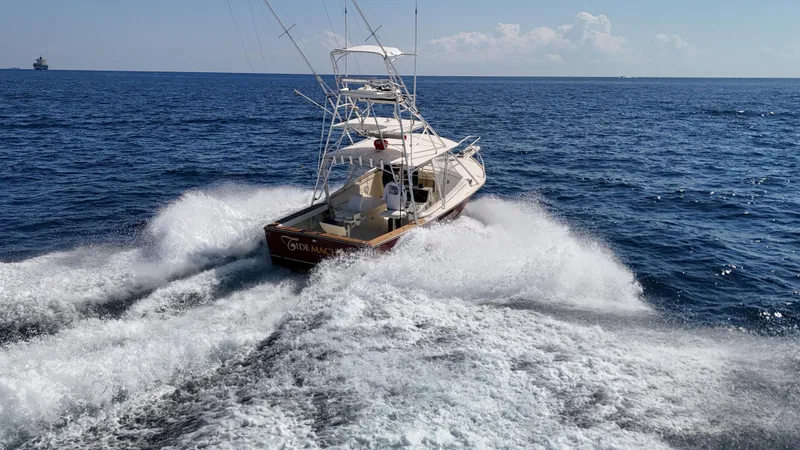 Slide: The Image of 1990 Gulf Stream Yachts 31 Tournament cruising on open ocean waters. - 24