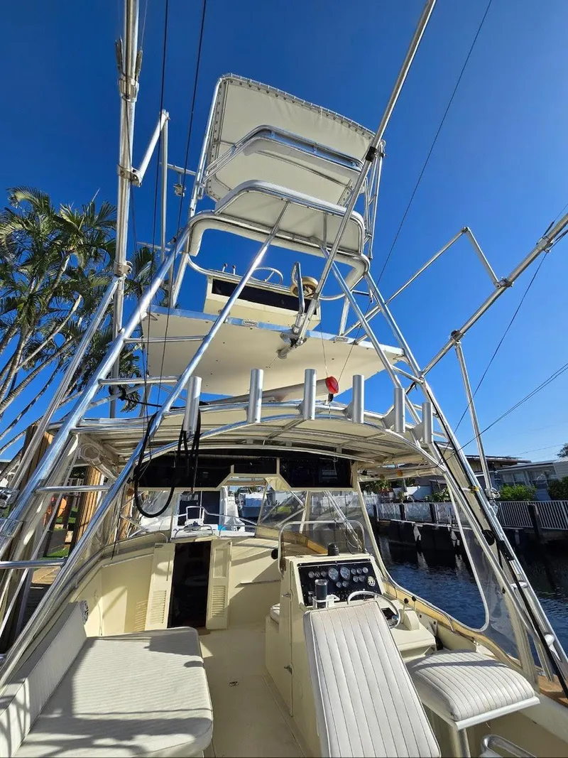 Slide: The Image of 1990 Gulf Stream Yachts 31 Tournament boat with tower, docked under clear blue sky. - 25