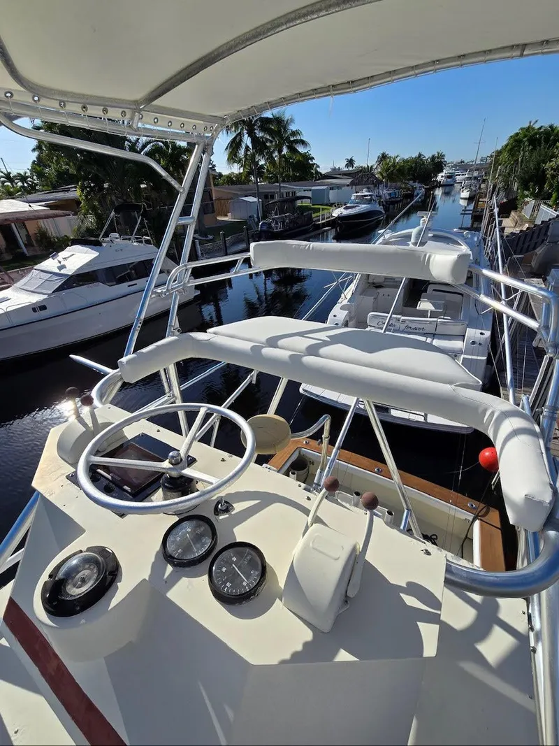 Slide: The Image of 1990 Gulf Stream Yachts 31 Tournament on a sunny canal, featuring a sleek helm and gauges. - 26