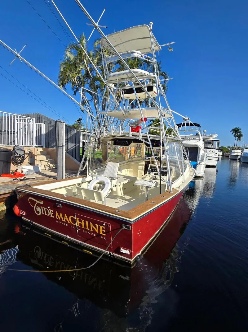 Slide: The Image of 1990 Gulf Stream Yachts 31 Tournament boat docked, featuring a red hull and fishing tower. - 28