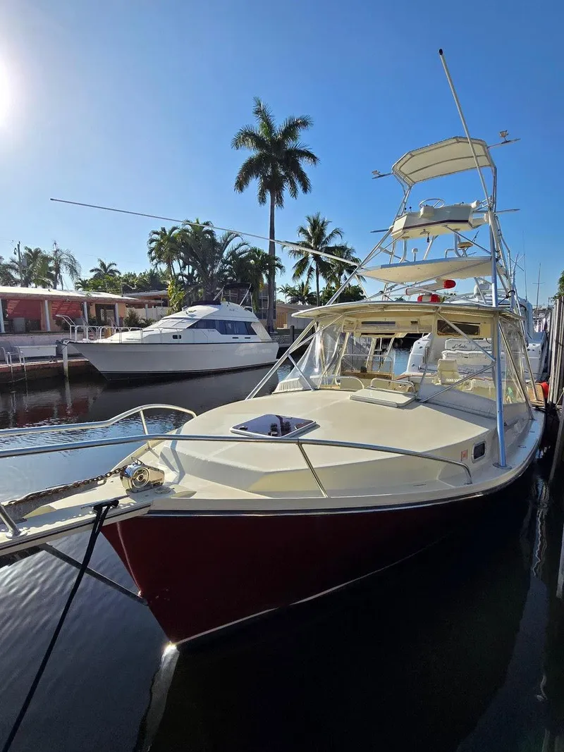 Slide: The Image of 1990 Gulf Stream Yachts 31 Tournament docked, with palm trees and clear sky in the background. - 30