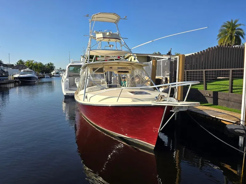 Slide: The Image of 1990 Gulf Stream Yachts 31 Tournament boat docked in a sunny marina. - 31