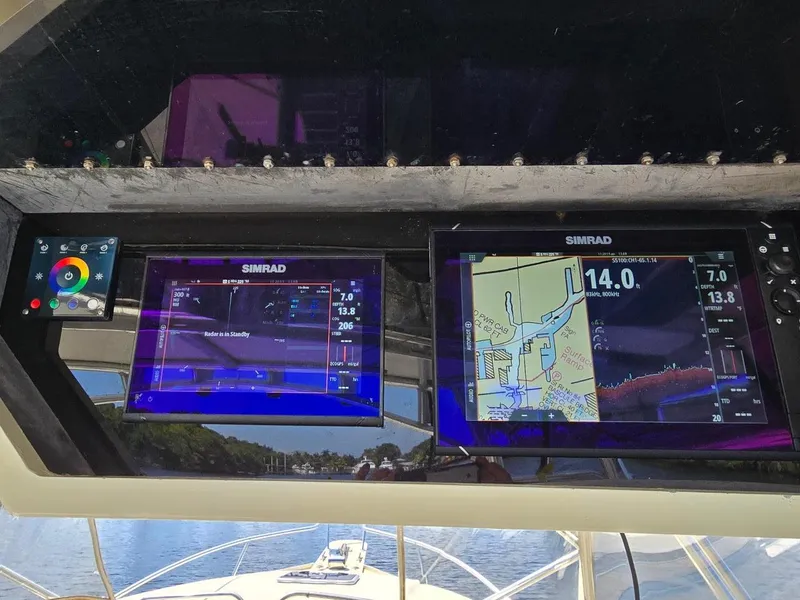Slide: The Image of Simrad navigation screens on 1990 Gulf Stream Yachts 31 Tournament boat dashboard. - 33