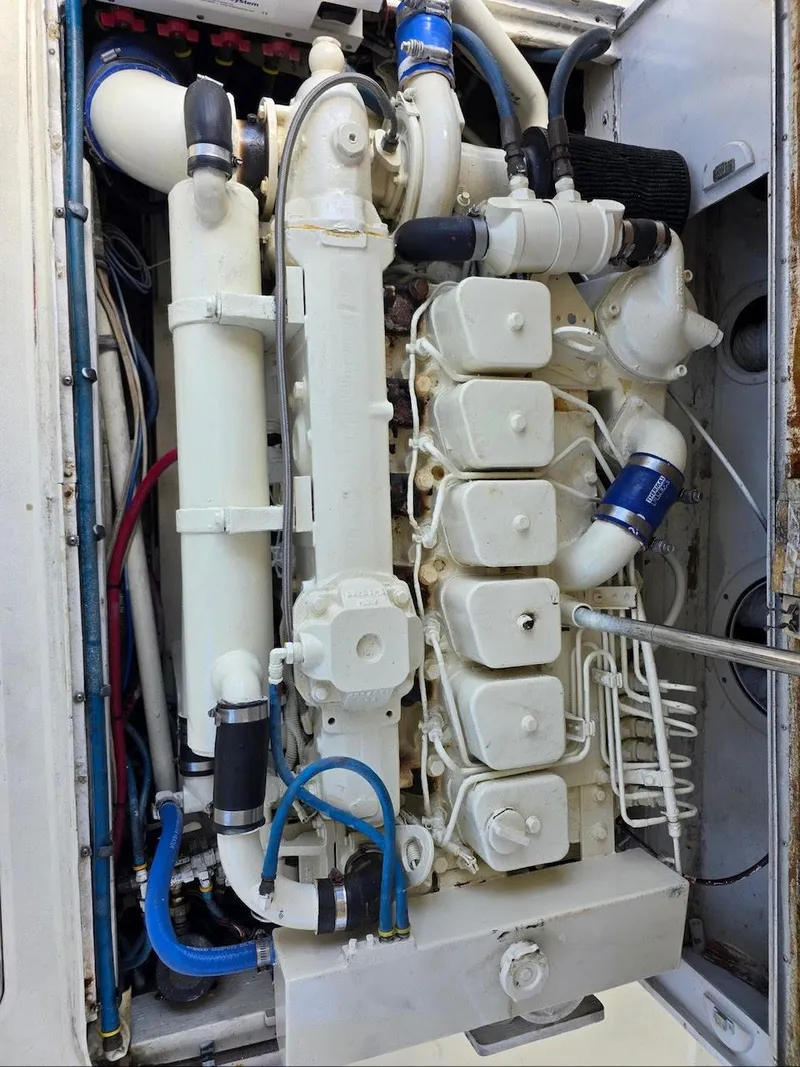 Slide: The Image of Engine compartment of a 1990 Gulf Stream Yachts 31 Tournament, showcasing detailed mechanical components. - 36