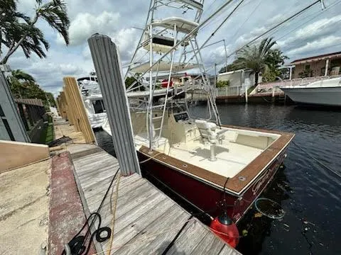 Slide: The Image of 1990 Gulf Stream Yachts 31 Tournament docked by a canal with palm trees. - 40