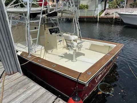Slide: The Image of 1990 Gulf Stream Yachts 31 Tournament boat docked, featuring a spacious deck and fishing chair. - 41