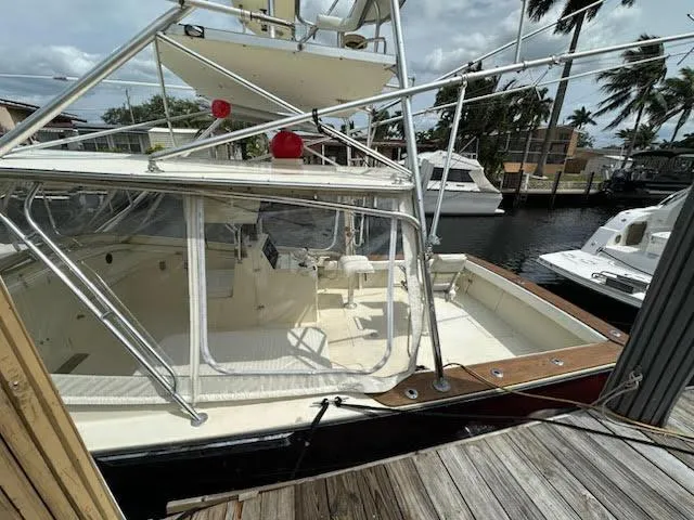 Slide: The Image of 1990 Gulf Stream Yachts 31 Tournament docked, featuring spacious deck and fishing equipment. - 42