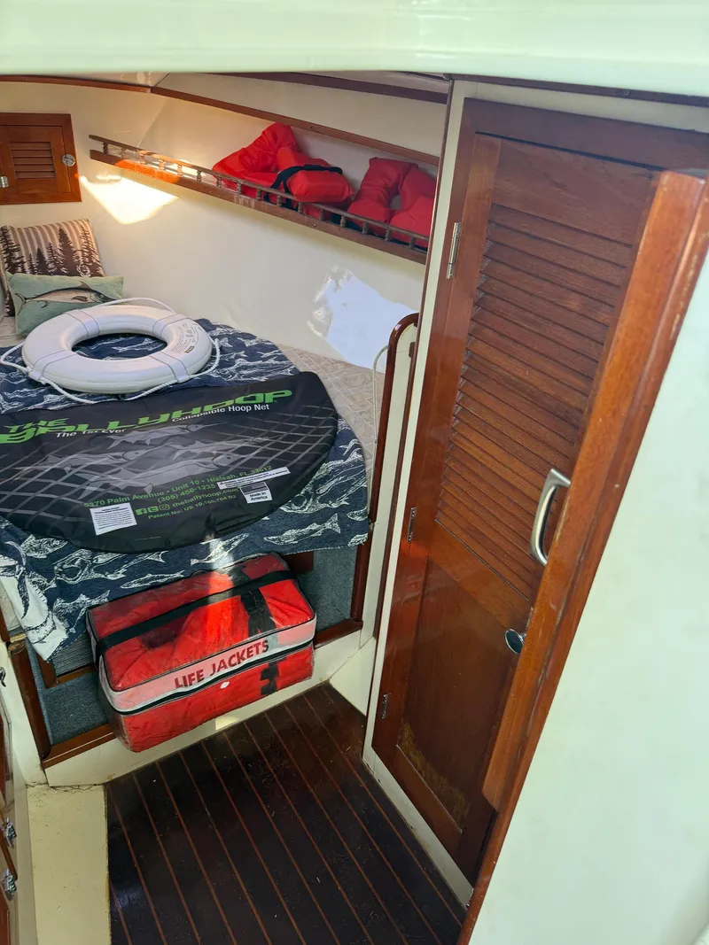 Slide: The Image of 1990 Gulf Stream Yachts 31 Tournament cabin interior with life jackets and storage. - 45