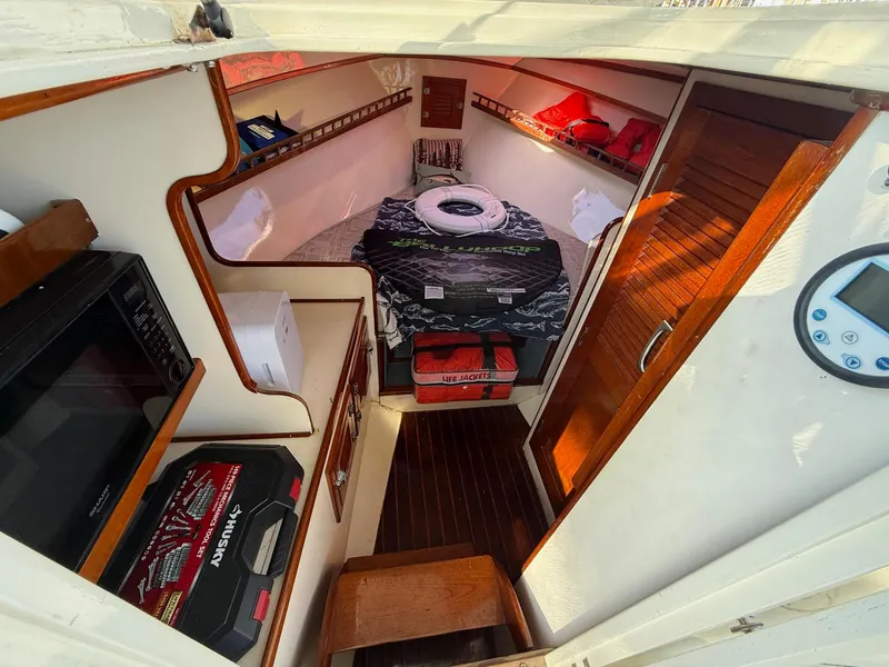 Slide: The Image of Interior of 1990 Gulf Stream Yachts 31 Tournament, featuring cozy cabin and storage. - 46