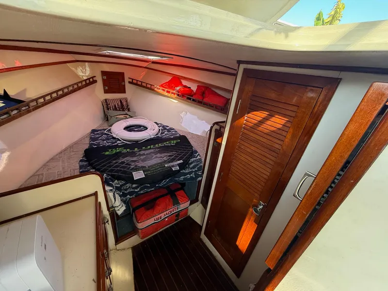 Slide: The Image of Interior of 1990 Gulf Stream Yachts 31 Tournament, featuring cozy cabin and wooden accents. - 48