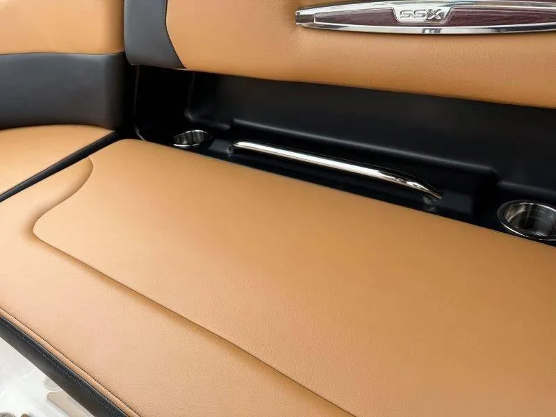 Slide: The Image of 2022 Chaparral 287 SSX boat interior with tan leather seating and SSX emblem. - 12