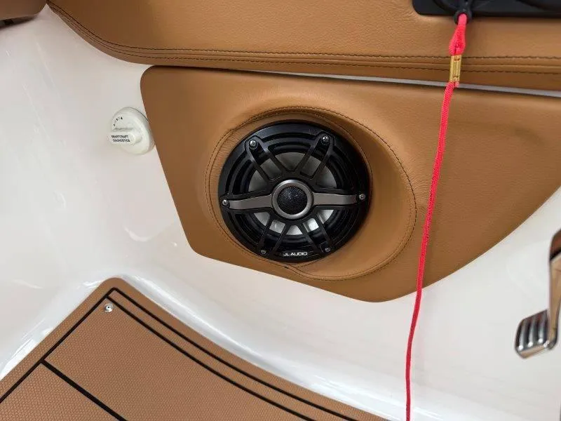 Slide: The Image of Speaker system in 2022 Chaparral 287 SSX boat, featuring tan interior and JL Audio speaker. - 13