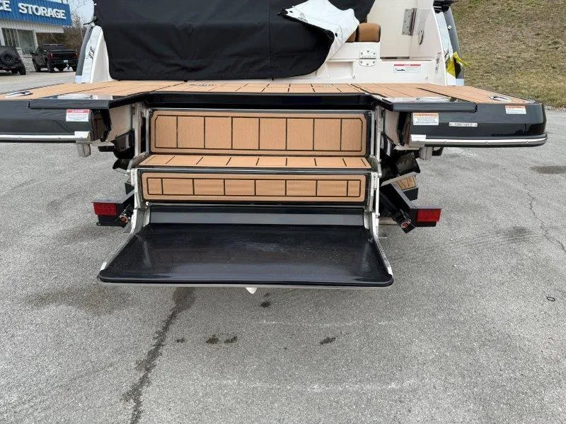 Slide: The Image of 2022 Chaparral 287 SSX boat with open rear storage compartment and seating. - 26