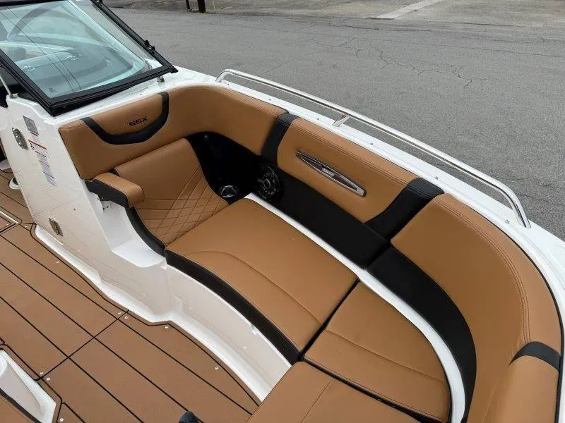 Slide: The Image of 2022 Chaparral 287 SSX boat interior with tan and black seating. - 29