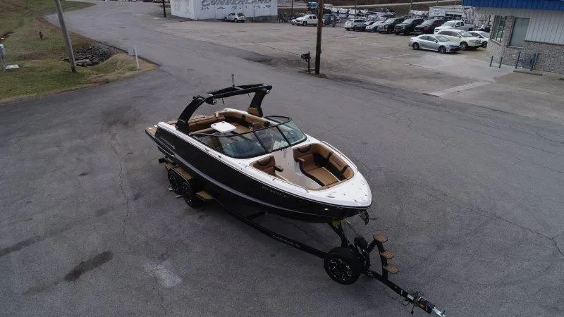 Slide: The Image of 2022 Chaparral 287 SSX boat on trailer in parking lot, aerial view. - 3