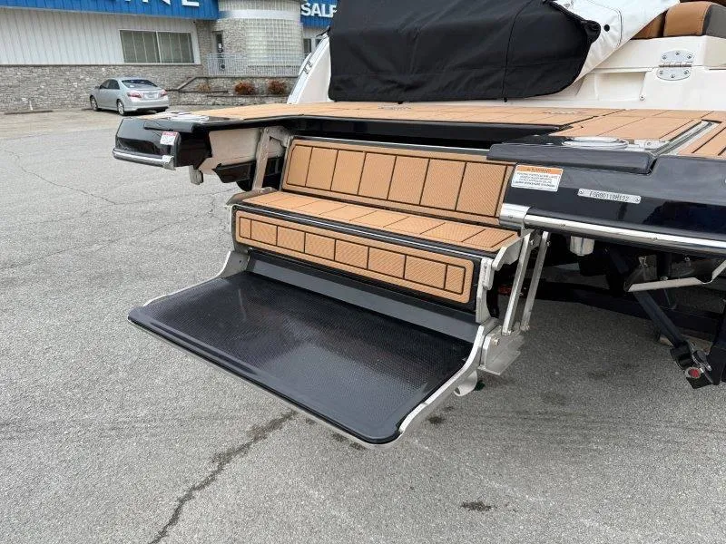 Slide: The Image of 2022 Chaparral 287 SSX swim platform with fold-out step, displayed outdoors. - 30