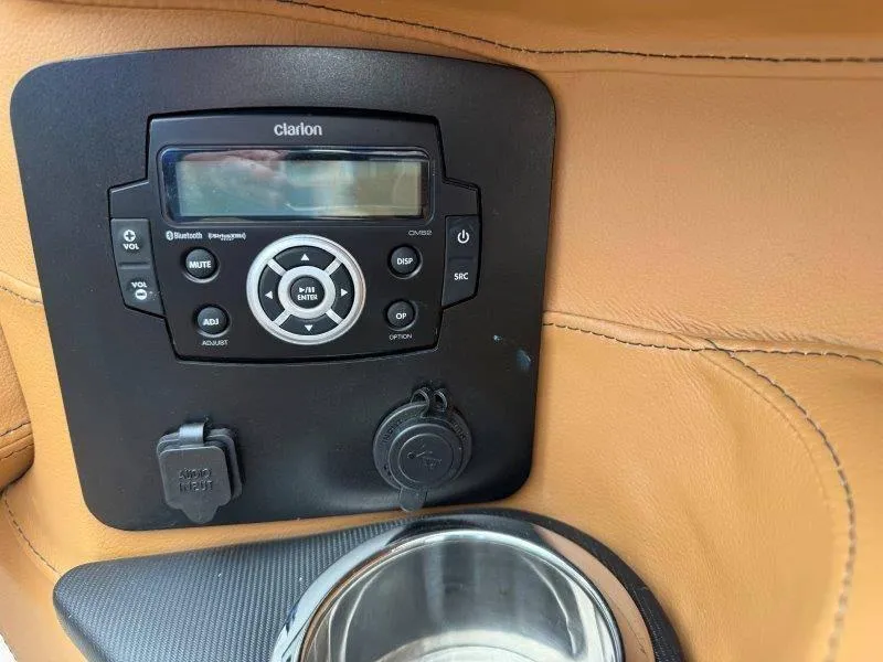 Slide: The Image of Clarion audio system in 2022 Chaparral 287 SSX boat with cup holder. - 32