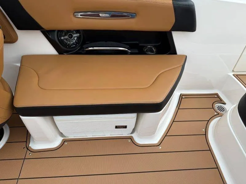 Slide: The Image of 2022 Chaparral 287 SSX boat interior with tan seating and teak-style flooring. - 34