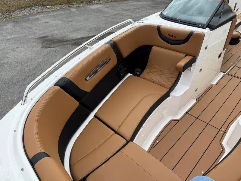Slide: The Image of 2022 Chaparral 287 SSX boat interior with tan and black seating, sleek design. - 39