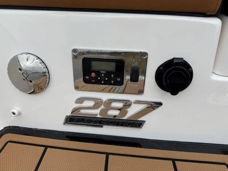 Slide: The Image of 2022 Chaparral 287 SSX Black Edition boat control panel and trim switch. - 41