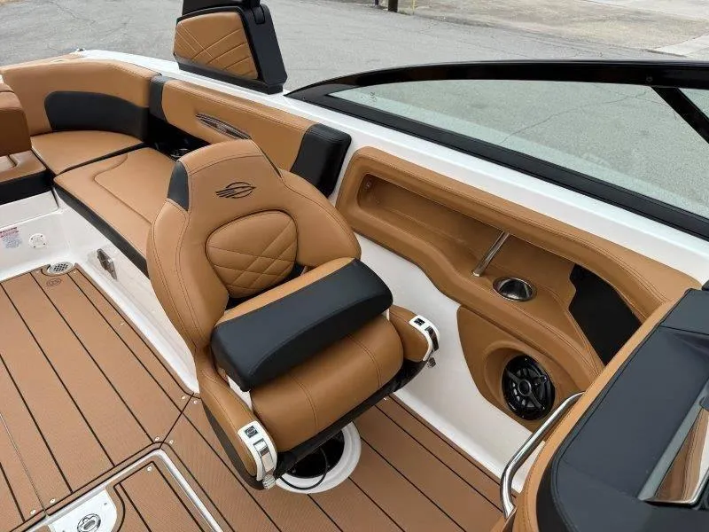 Slide: The Image of 2022 Chaparral 287 SSX boat interior with tan and black seating, modern design. - 45