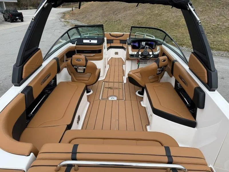 Slide: The Image of 2022 Chaparral 287 SSX boat interior with tan seating and sleek design. - 47